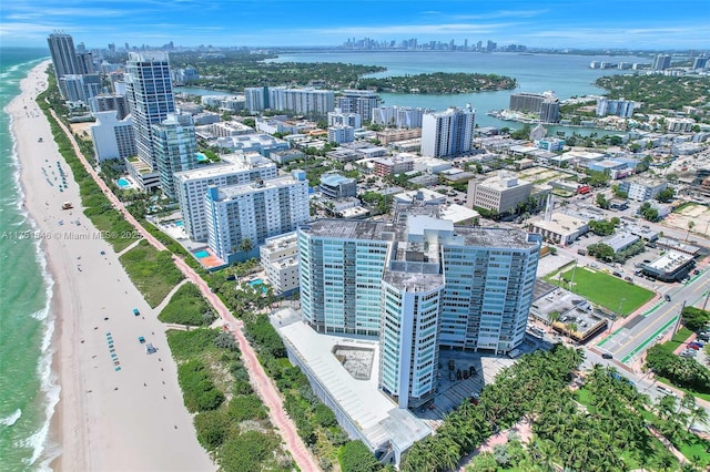 birds eye view of property with a view of city, a water view, and a beach view