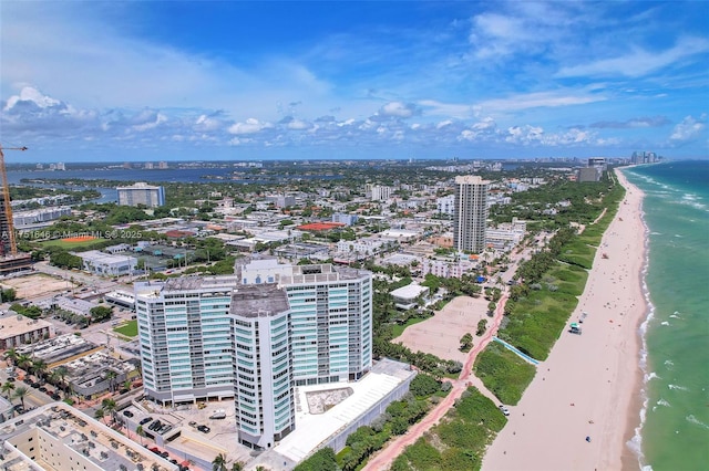 birds eye view of property featuring a water view, a view of city, and a beach view