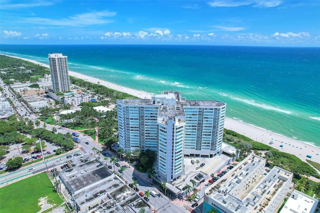 aerial view featuring a water view, a city view, and a view of the beach