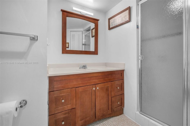 bathroom featuring a shower stall and vanity