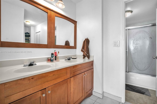 bathroom featuring double vanity, tile patterned flooring, combined bath / shower with glass door, and a sink