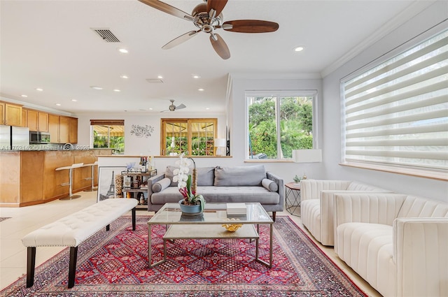 living area featuring recessed lighting, visible vents, crown molding, and light tile patterned flooring