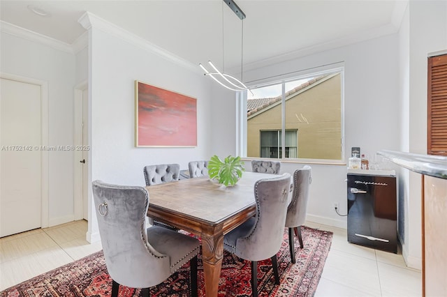 dining room with light tile patterned floors, baseboards, and crown molding