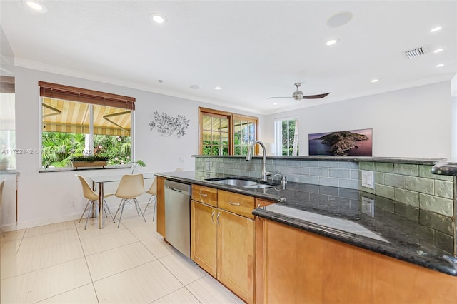 kitchen featuring visible vents, decorative backsplash, a sink, dark stone countertops, and dishwasher