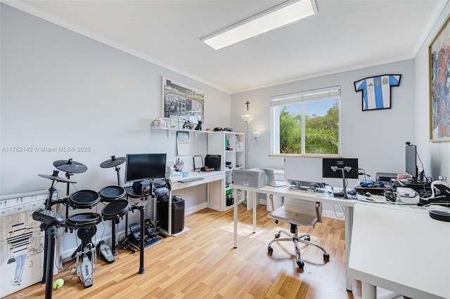 office area with light wood finished floors and ornamental molding