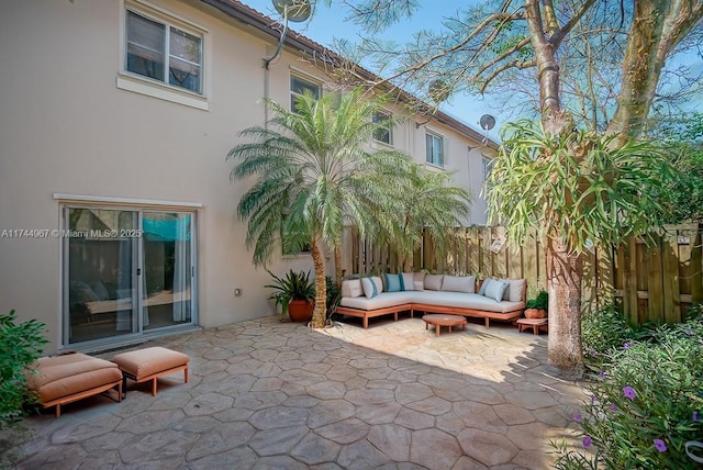 view of patio with outdoor lounge area and fence