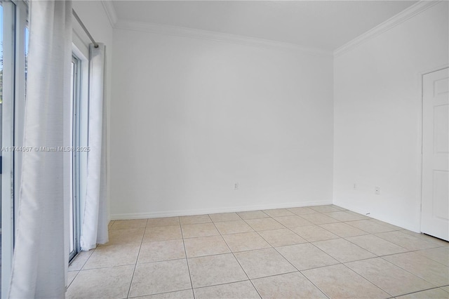 unfurnished room featuring light tile patterned flooring, crown molding, and baseboards