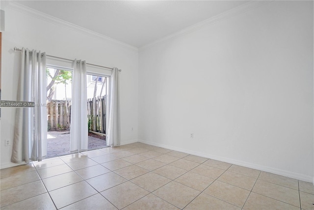 spare room with ornamental molding, light tile patterned floors, and baseboards