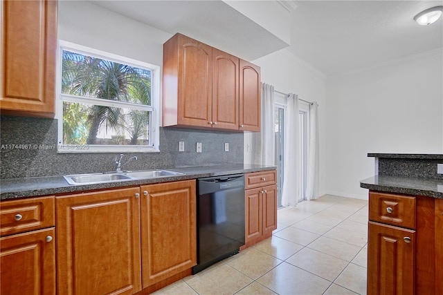 kitchen with a sink, light tile patterned floors, dark countertops, and dishwasher