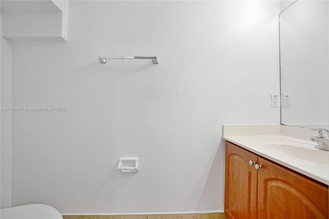 bathroom featuring toilet and vanity