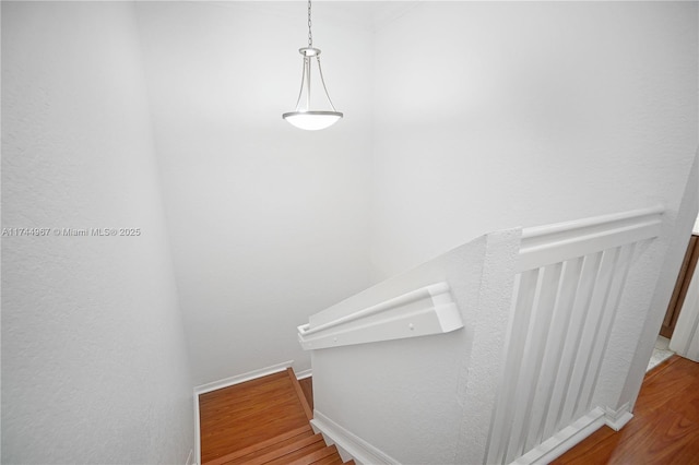 stairs featuring baseboards and wood finished floors