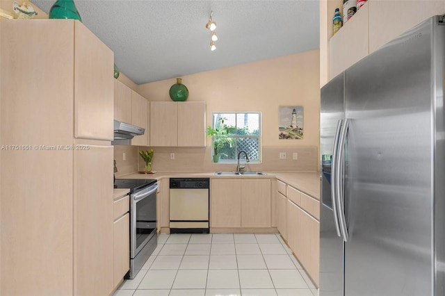 kitchen featuring light tile patterned floors, stainless steel appliances, light countertops, a sink, and under cabinet range hood