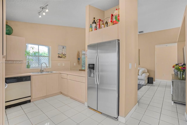 kitchen with stainless steel fridge with ice dispenser, dishwashing machine, light countertops, light brown cabinets, and a sink