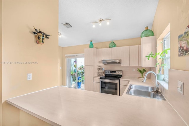 kitchen with stainless steel electric stove, visible vents, light countertops, a sink, and under cabinet range hood