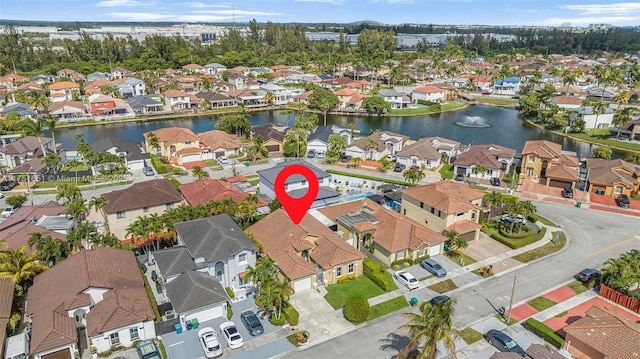 bird's eye view featuring a water view and a residential view