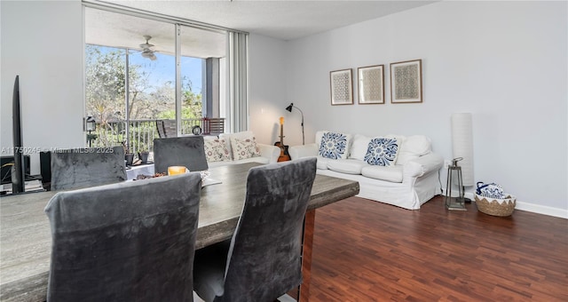 dining space with expansive windows, ceiling fan, wood finished floors, and baseboards