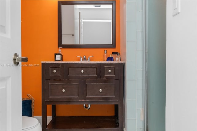 bathroom with toilet and vanity