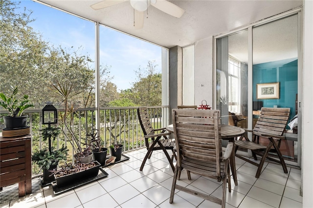 sunroom / solarium featuring ceiling fan