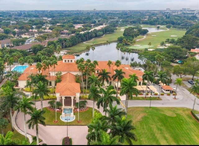 drone / aerial view with a water view and golf course view