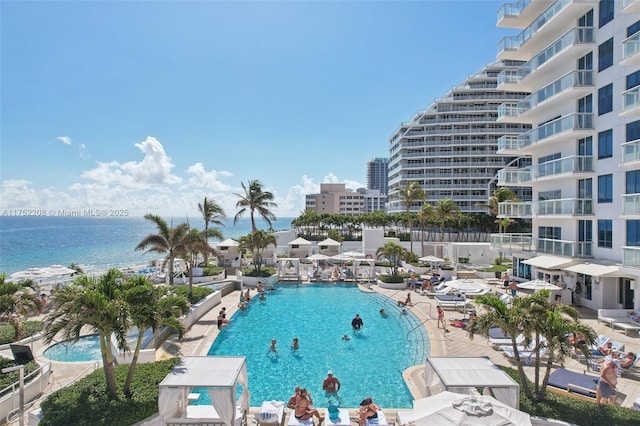 pool with a water view and a patio