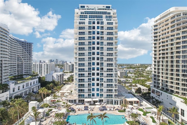 view of building exterior with a view of city and a community pool