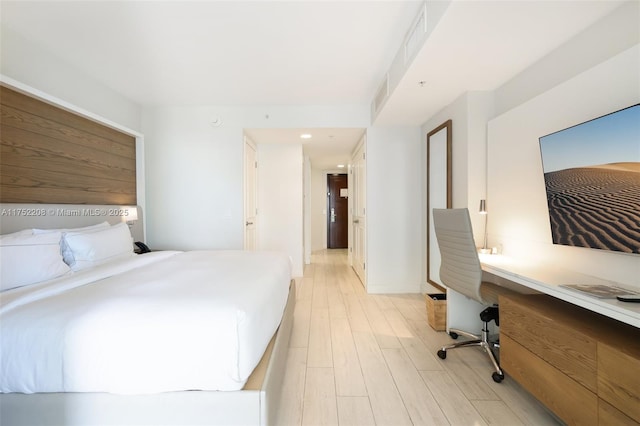 bedroom with light wood-type flooring, baseboards, and visible vents