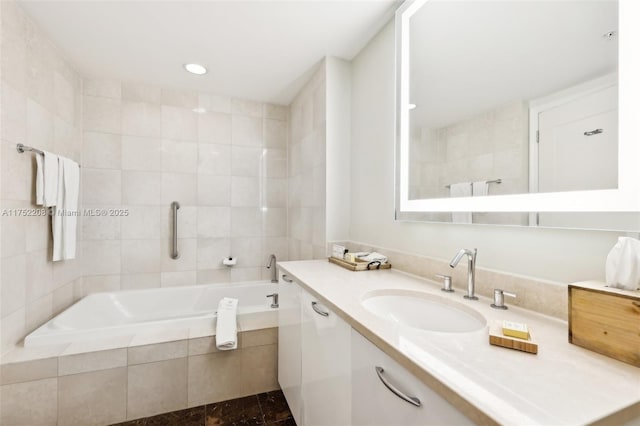 full bathroom with a garden tub, recessed lighting, and vanity