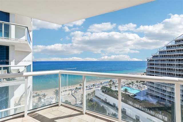 balcony featuring a view of the beach and a water view