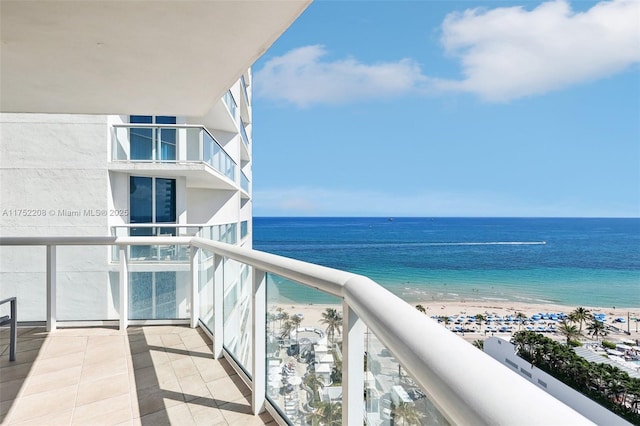 balcony with a water view and a beach view