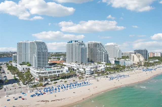 aerial view featuring a view of city, a water view, and a beach view