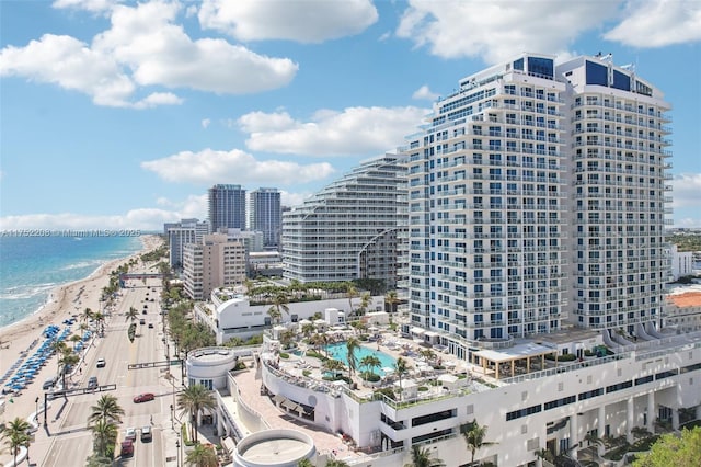 exterior space with a water view, a city view, and a view of the beach