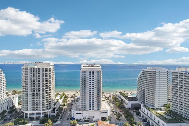 drone / aerial view with a view of city, a water view, and a beach view