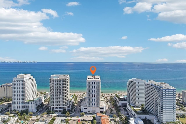 birds eye view of property featuring a water view, a view of city, and a view of the beach