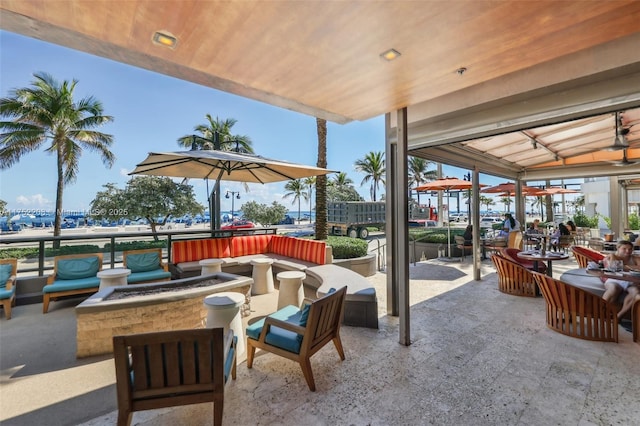 view of patio / terrace with an outdoor living space with a fire pit