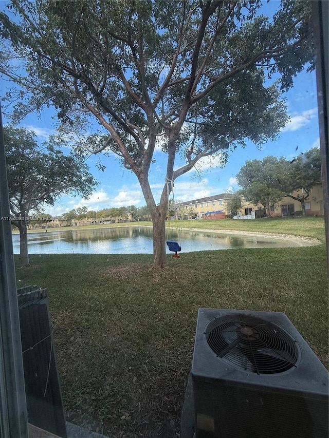 view of yard with a water view and cooling unit