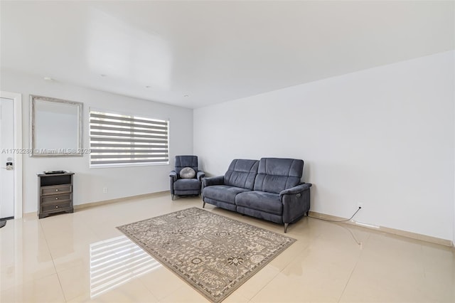 living room with baseboards and light tile patterned flooring