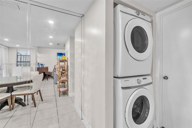 laundry room featuring stacked washer and dryer, recessed lighting, laundry area, and light tile patterned floors