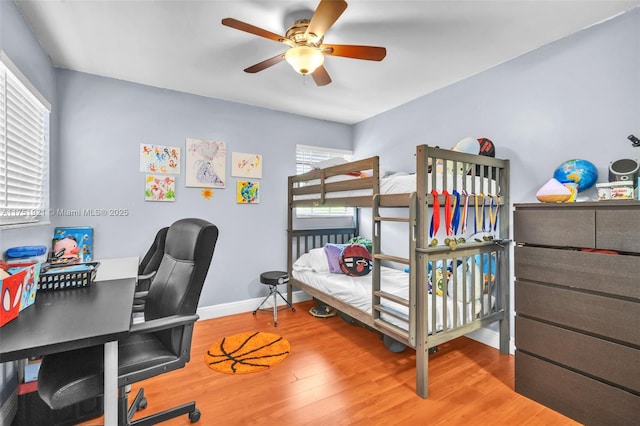 bedroom featuring baseboards and wood finished floors