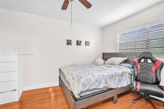 bedroom featuring ceiling fan, wood finished floors, and baseboards