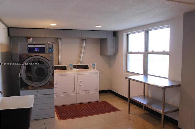 shared laundry area featuring light floors, washing machine and clothes dryer, recessed lighting, a textured ceiling, and baseboards