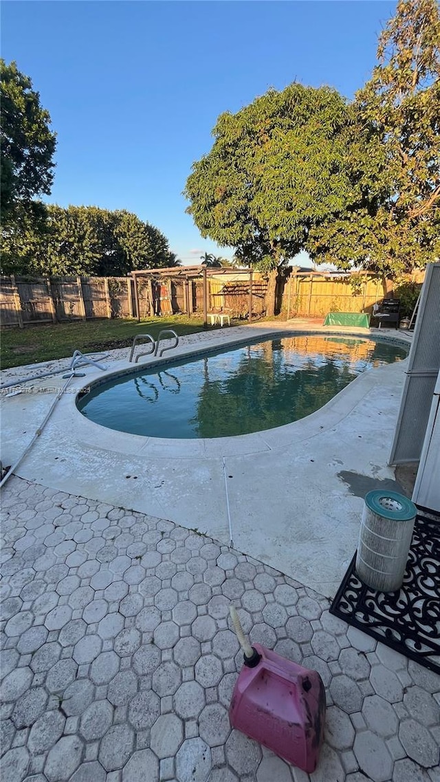 view of pool with a fenced in pool, a fenced backyard, and a patio