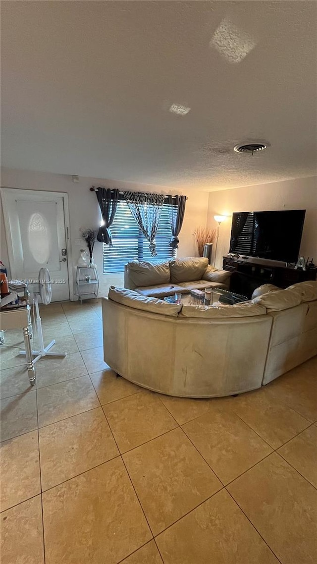 living room with light tile patterned floors and a textured ceiling