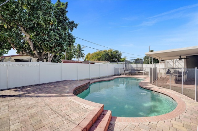 view of swimming pool featuring a patio, a fenced backyard, and a fenced in pool