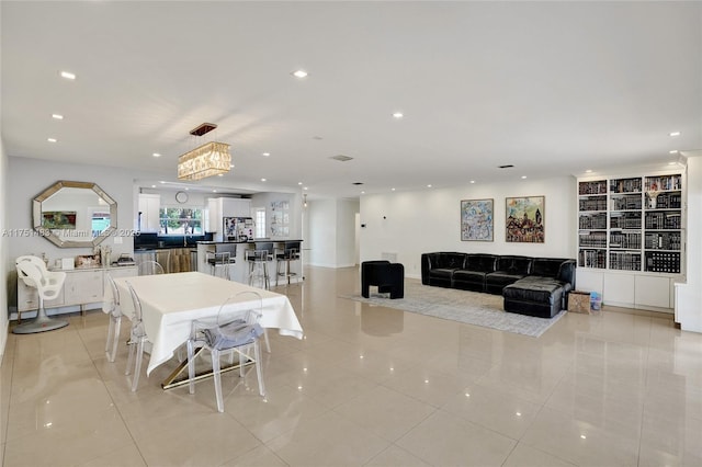 dining space with light tile patterned flooring and recessed lighting