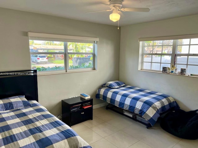 bedroom with a ceiling fan and light tile patterned flooring