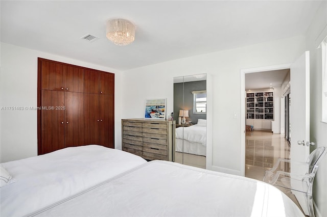 bedroom with visible vents and a closet