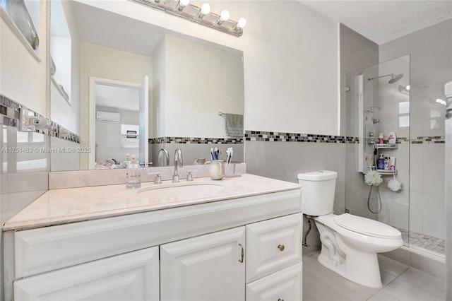 full bathroom with tile walls, toilet, a stall shower, vanity, and tile patterned floors