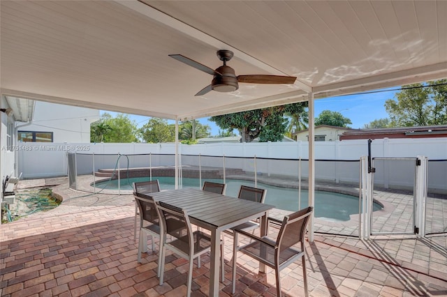 view of patio with a fenced in pool, outdoor dining space, a fenced backyard, and a ceiling fan