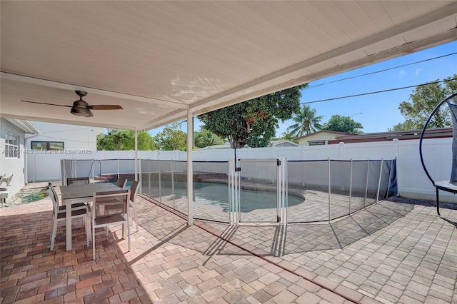 view of patio featuring a fenced backyard, a ceiling fan, outdoor dining area, and a fenced in pool