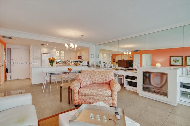 living area with light tile patterned floors, crown molding, visible vents, and an inviting chandelier